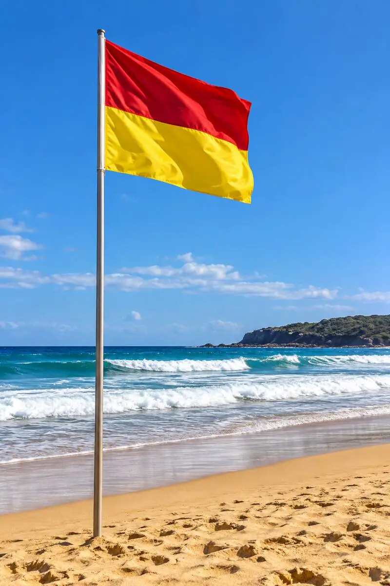Red and yellow surf lifesaving flags planted on an Australian patrolled beach